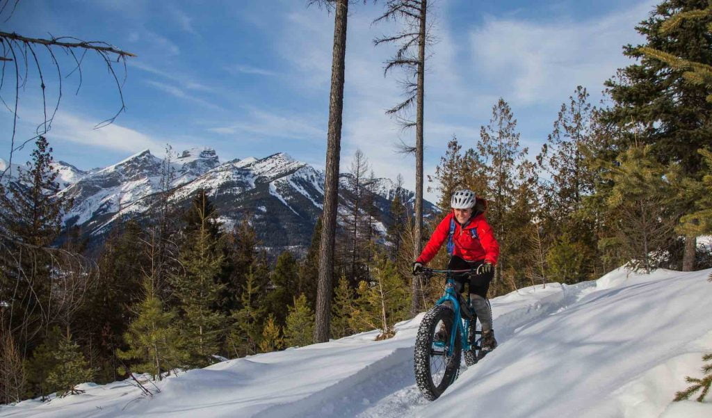 woman on fatbike with 3 sisters in background