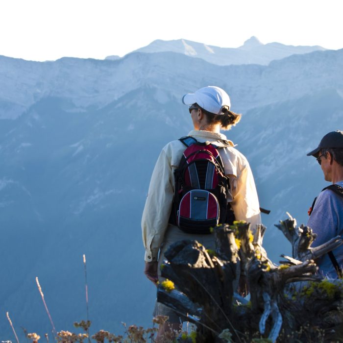 Couple resting while hiking and looking out over valley in Fernie BC