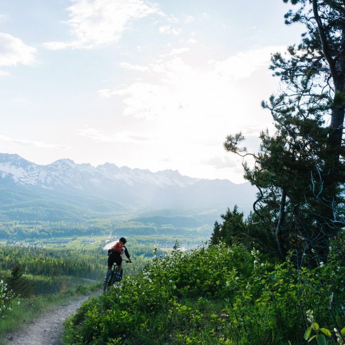 mountain biking in Fernie down a trail with view of Lizard Range near Fernie BC_photo by Kyle Hamilton